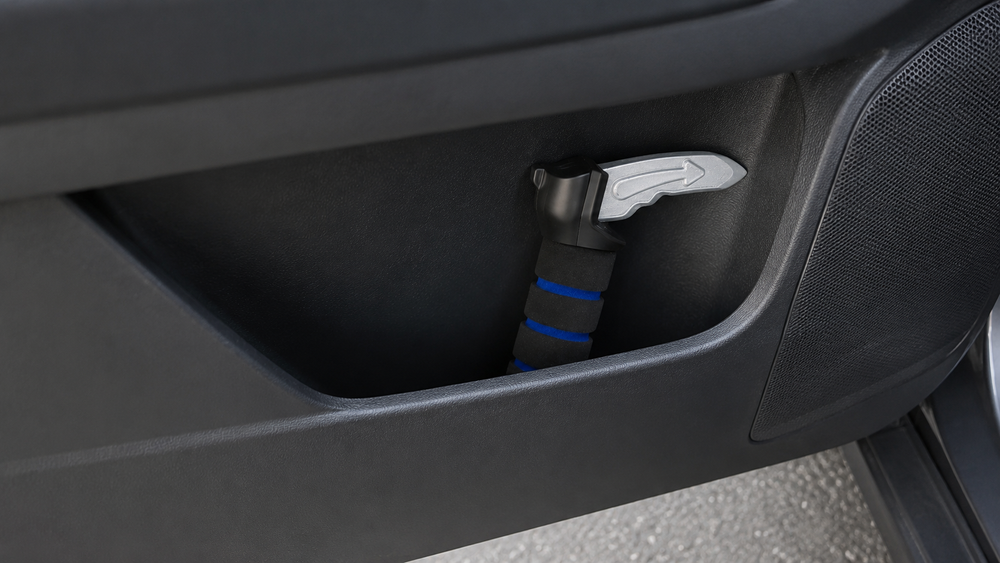 A hand lifting the handle out of the striker and placing it into the door pocket.